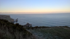View of cliffs above tunnel beach from trail.