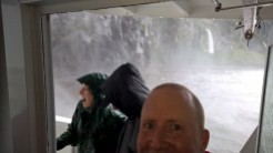 getting wet under the waterfall at Milford Sound